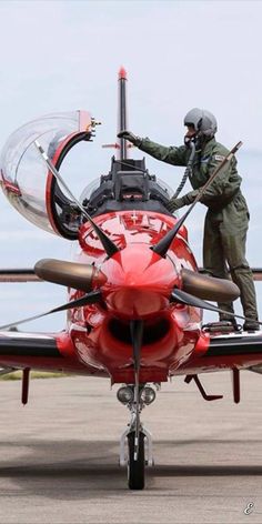 a man standing on the wing of an airplane