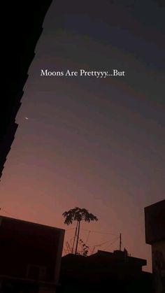 the moon is seen in the sky above some buildings and trees at night, with an inspirational quote written on it