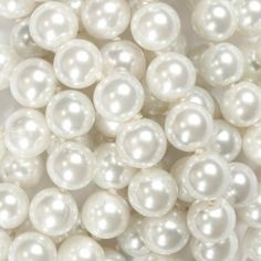 white pearls are arranged in rows on a white surface