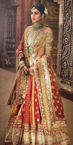 a woman in a red and gold bridal gown