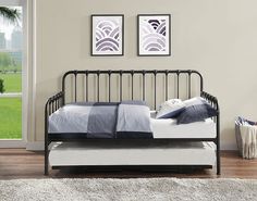 a day bed with a pull out trundle underneath it