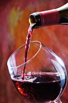 red wine being poured into a glass