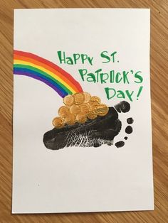 a st patrick's day card with a dog paw and rainbow