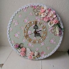 a clock decorated with flowers and pearls