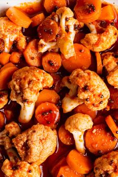 cooked carrots and cauliflower with sauce in a white bowl