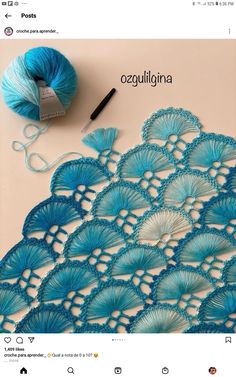 a crochet doily with yarn next to it on top of a table
