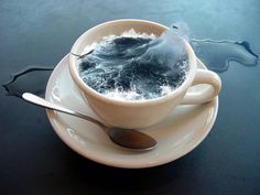 a cup filled with water sitting on top of a saucer