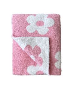 a pink and white blanket with hearts on it's side, in the shape of a flower