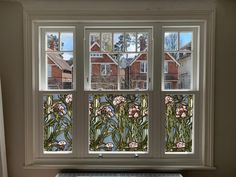 an image of a window with flowers in the glass and some windowsills behind it