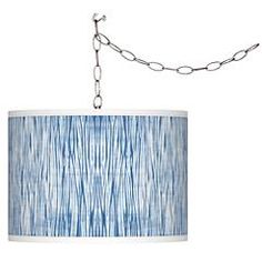 a blue lamp hanging from a chain