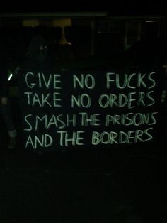 a sign that says give no fuks take no orders smash the prison and the borders