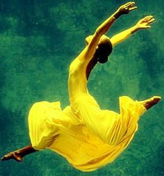 a man in yellow shirt and pants doing a trick on a skateboard under water