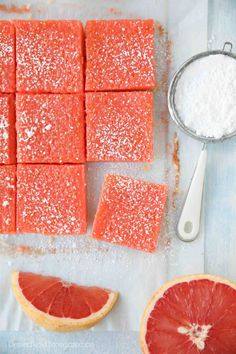 grapefruit bars with powdered sugar on top and blood orange slices next to them