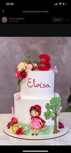 a three tiered birthday cake decorated with flowers and a little red riding on the horse