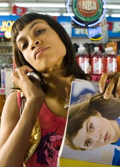 a woman holding up a magazine in front of her face