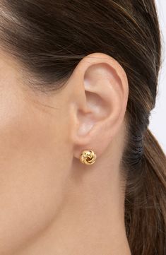 An intricately knotted design adds a thoughtful and elegant style to these stud earrings. 9mm length Post back White rhodium or gold plated brass
 Polish gently with cloth Imported Gold Stud Earrings Set, Timeless Gold Earrings, Gold Elegant Earrings, Brass Polish, Cartier Earrings, Large Stud Earrings, Trend Jewelry, Rose Gold Earrings Studs, Knot Stud Earrings