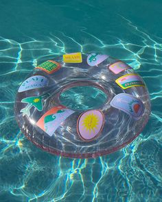 an inflatable ring floating on top of the water with stickers attached to it