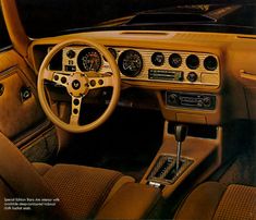 the interior of an old car with wood trim and gauges on it's dash board