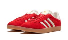 The Women’s adidas Gazelle “Red” is a women’s-exclusive colorway of the retro shoe with a bold, red-based design.  An eye-catching yet versatile shoe, the adidas Gazelle “Red” features a red suede upper and white leather Three Stripes branding on the sides.  A gold “Gazelle” logo appears on the lateral side of the mid-panel, while classic “adidas” branding is seen on the white leather heel tab.  More “adidas” detailing can be found on the tongue.  A gum rubber sole completes the look. Red Sneakers Women, Red Gazelle, Adidas Shoes Gazelle, Adidas Gazelle Women, Stripes Branding, Jordan New, Adidas Branding, Womens Red Shoes, Classic Adidas