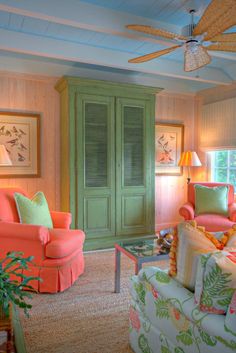 a living room filled with lots of furniture next to a wall mounted fan and window