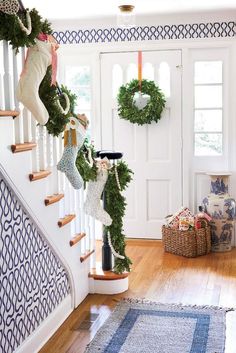 an instagram page with christmas wreaths hanging from the banister and garland on the stairs