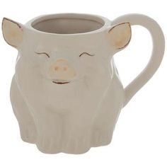 a ceramic mug with a pig face on the front and side of it's body