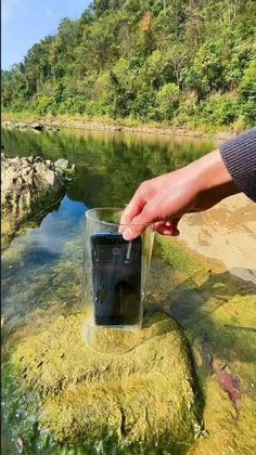 a person is reaching for a glass in the water