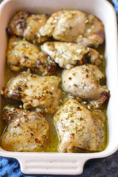 chicken with olive sauce in a white casserole dish