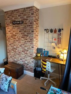 a bedroom with a brick wall and desk