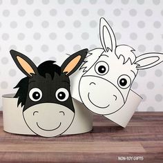 two paper cups with donkeys on them sitting next to each other in front of a polka dot wall