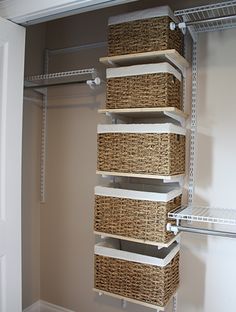 an image of a closet with baskets on the bottom shelf and two shelves below it