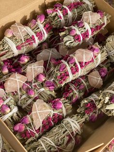 a box filled with lots of different types of flowers next to boxes of soaps