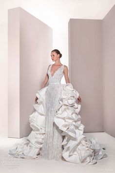 a woman in a white wedding dress is posing for the camera