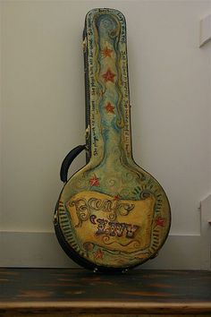 a guitar case sitting on top of a wooden shelf