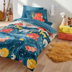 a child's bedroom with blue bedding and animal themed comforter sets on the floor