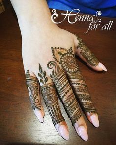 the hand is decorated with henna on it and has an intricate pattern in the middle