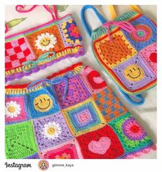 two crocheted purses with flowers and hearts on them, one is multicolored