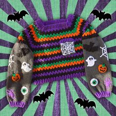 Black, purple, green and orange striped crochet jumper / sweater with spider web chest pocket and grey sleeves with bat, pumpkin, ghost, eyeball, spider and spider web applique designs. Cropped Spooky Season Sweater / Jumper by VelvetVolcano Orange And Emerald Green, Spider Web Strawberries, Spider Web Pumpkin, Granny Stitch, White Spider, Ghost Spider, Crochet Jumper, Classic Halloween, Bunny Doll