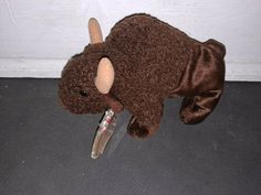 a brown stuffed animal laying on top of a floor