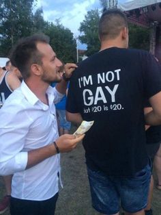 two men standing next to each other eating food