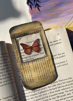 an open book with a butterfly on it