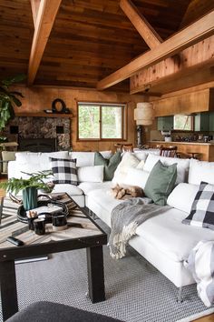 a living room filled with lots of furniture and a fire place in the middle of it