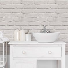 a white sink sitting on top of a wooden table