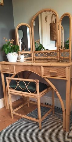 a bamboo desk with mirror and plant in it