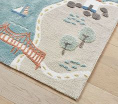 an area rug with a bridge and trees on it