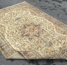 two rugs are laying on the ground next to each other, one is beige and brown