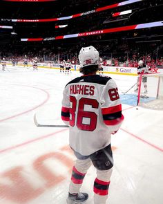 a hockey player is standing on the ice in front of an empty arena with fans