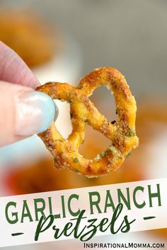 a person holding up a pretzel with the words garlic ranch pretzels on it