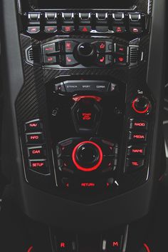 the interior of a car with red and black lights on it's dash panel