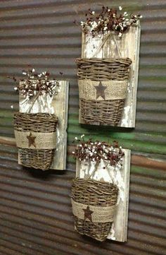 three baskets are hanging on the wall in front of a metal door with stars and flowers